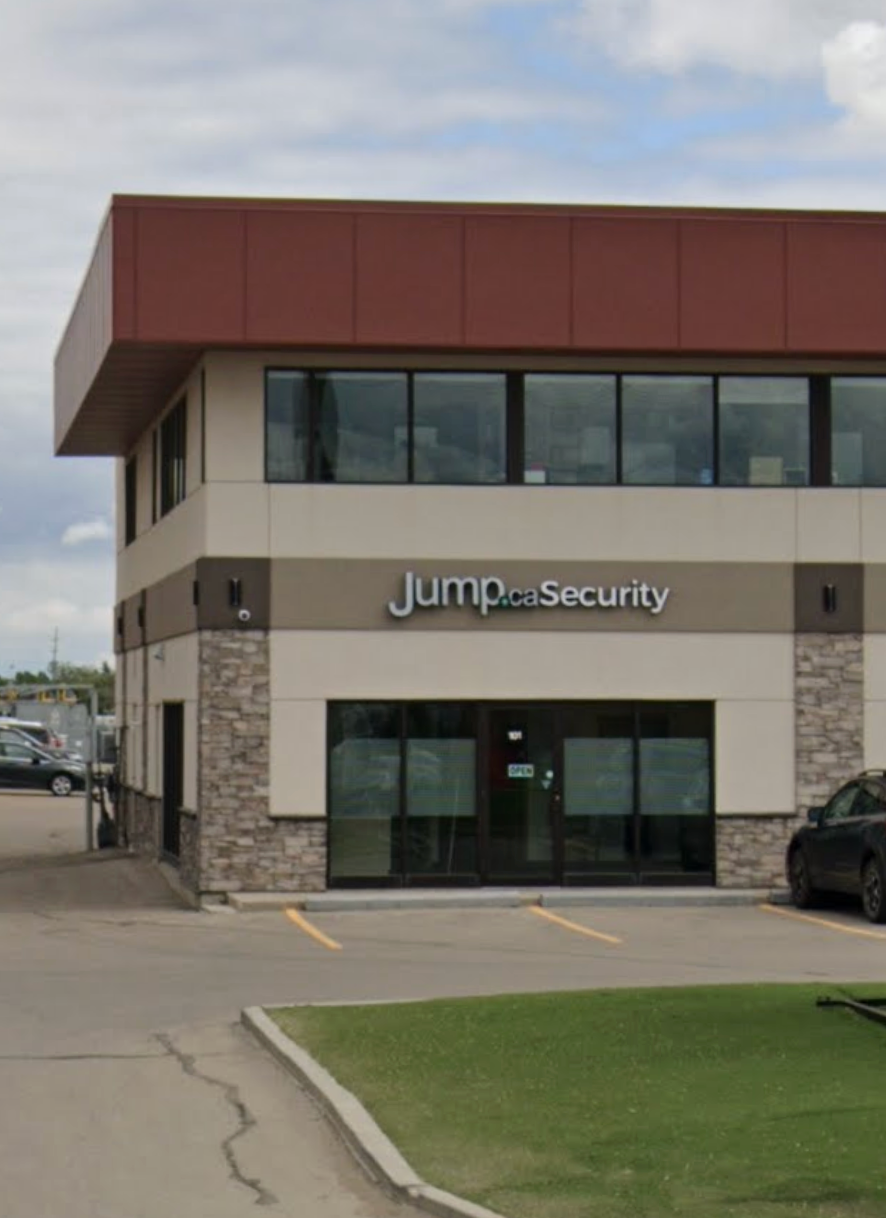 Storefront signs for 'Jump.ca' and 'SaskTel Authorized Dealer' with the SaskTel logo in blue and white, against a modern building facade.